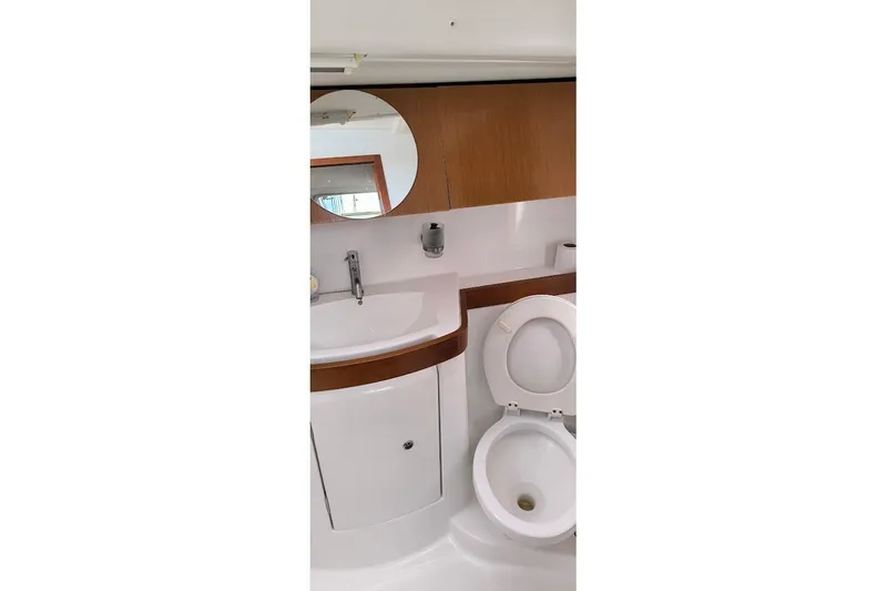 Slide: The Image of Beneteau Oceanis 40 yacht bathroom with sink, mirror, and toilet, 2011 model. - 48