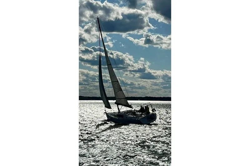 Slide: The Image of Sailing yacht Beneteau Oceanis 40, 2010 model, gliding on shimmering water under cloudy sky. - 12