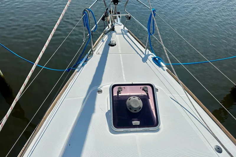 Slide: The Image of Deck view of a 2010 Beneteau Oceanis 40 sailboat with ropes and hatch. - 26