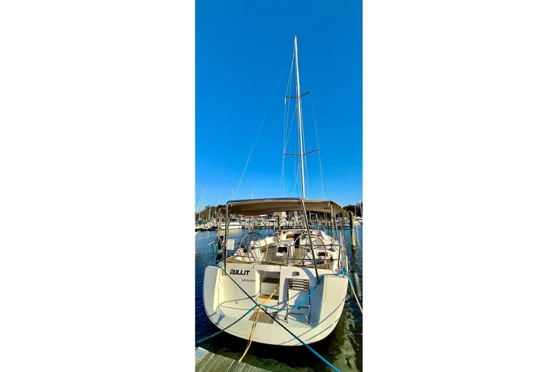 Slide: The Image of 2011 Beneteau Oceanis 40 sailboat docked at marina under clear blue sky. - 8