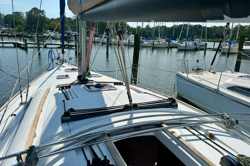 Slide: The Image of 2010 Beneteau Oceanis 40 sailboat docked at marina, showcasing deck and rigging. - 19
