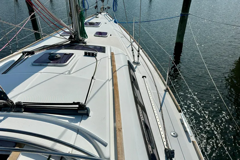 Slide: The Image of Deck view of 2010 Beneteau Oceanis 40 sailboat docked on calm water. - 18