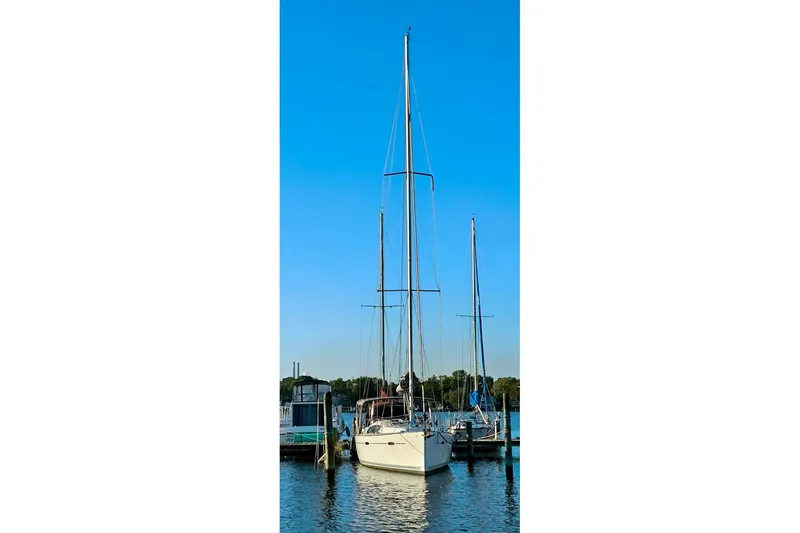 Slide: The Image of 2011 Beneteau Oceanis 40 sailboat docked in a marina under clear blue skies. - 11