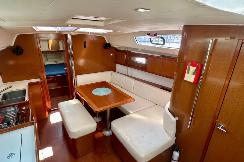Slide: The Image of Interior of 2010 Beneteau Oceanis 40 yacht with cozy seating and wooden finishes. - 40