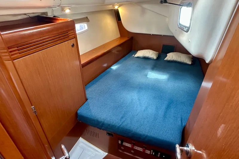 Slide: The Image of Cozy cabin interior of 2010 Beneteau Oceanis 40 sailboat with blue bedding. - 49