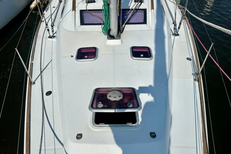 Slide: The Image of 2010 Beneteau Oceanis 40 yacht deck with open hatches and rigging. - 27