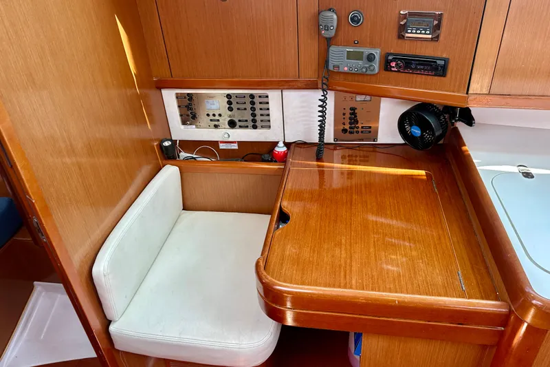 Slide: The Image of Interior of 2010 Beneteau Oceanis 40 sailboat with navigation station and control panel. - 43