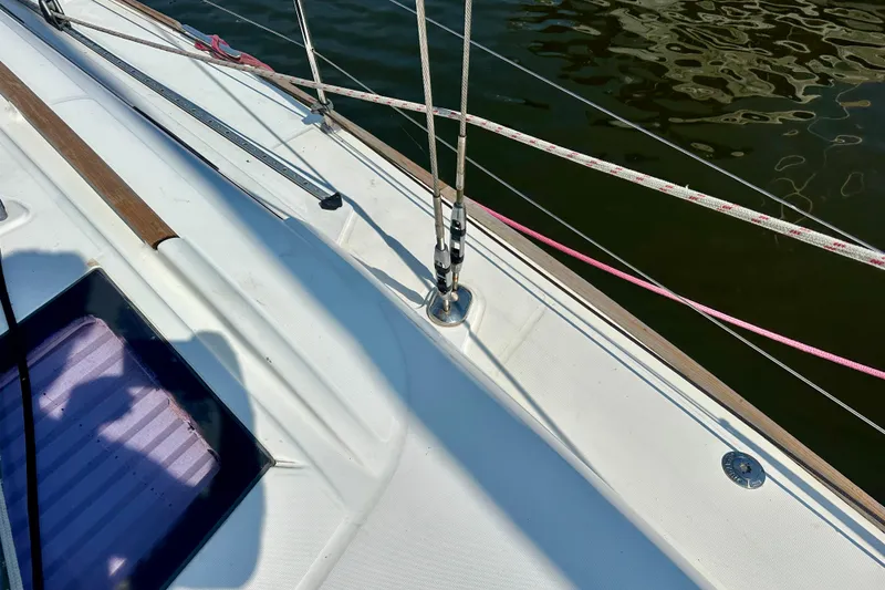 Slide: The Image of Deck of 2010 Beneteau Oceanis 40 sailboat with rigging and water reflection. - 25