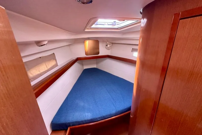 Slide: The Image of Cozy cabin interior of 2010 Beneteau Oceanis 40 sailboat with blue bedding. - 47