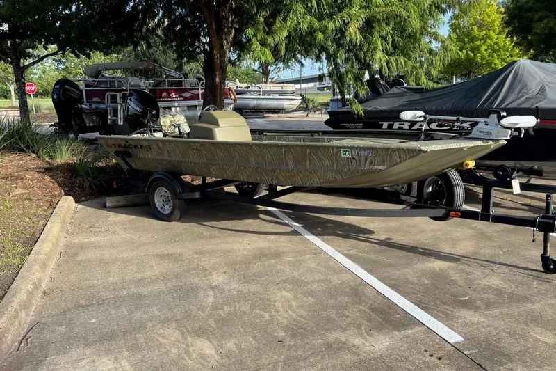 Slide: The Image of 2014 Tracker Grizzly 1754 SC boat on trailer in parking lot. - 6