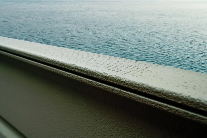 Slide: The Image of Close-up of a boat deck overlooking calm water. - 17