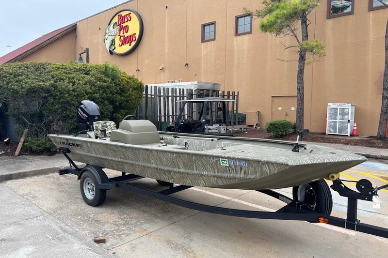 Slide: The Image of 2014 Tracker Grizzly 1754 SC boat on trailer outside Bass Pro Shops. - 1