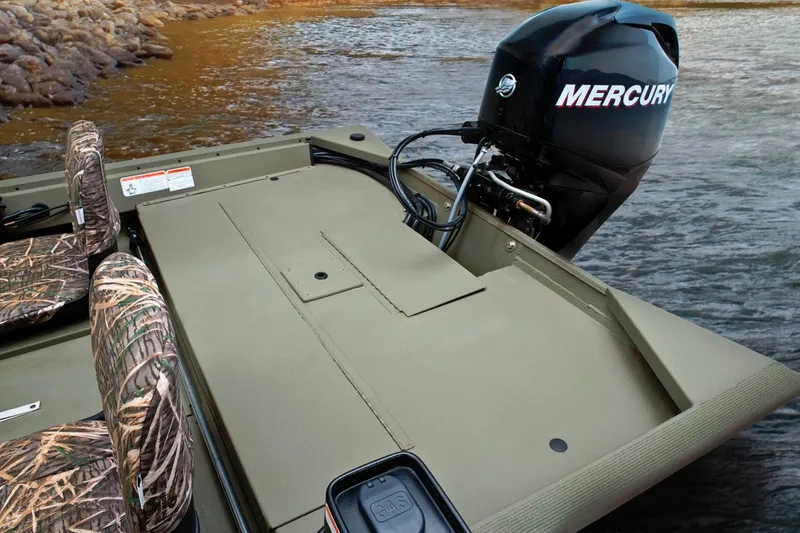 Slide: The Image of A 2024 Tracker Grizzly 1754 SC with a Mercury outboard motor. Camouflage seats and sturdy construction are visible. - 29