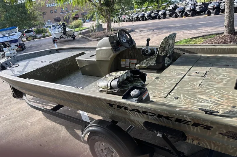 Slide: The Image of 2014 Tracker Grizzly 1754 SC boat with camouflage seats on a trailer. - 5