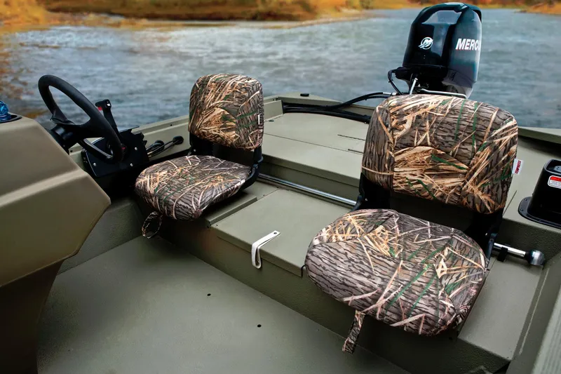 Slide: The Image of The image shows the interior of a Tracker Grizzly 1754 SC boat with two camo-patterned seats. - 28