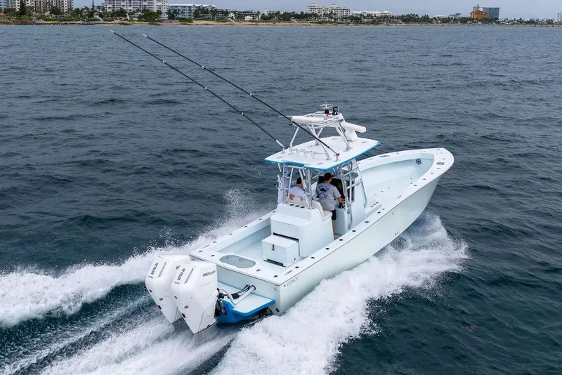 Slide: The Image of 2019 Conch 33 boat cruising on ocean near coastline. - 2