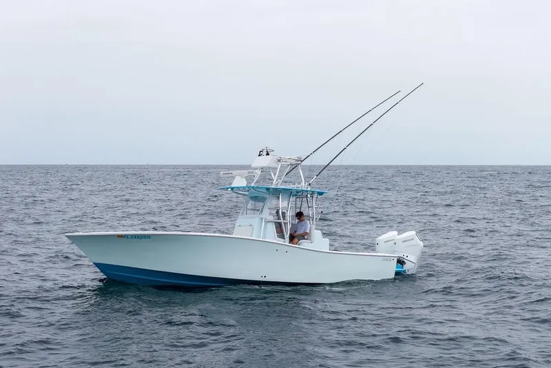 Slide: The Image of 2019 Conch 33 boat on open sea with fishing rods and dual engines. - 13