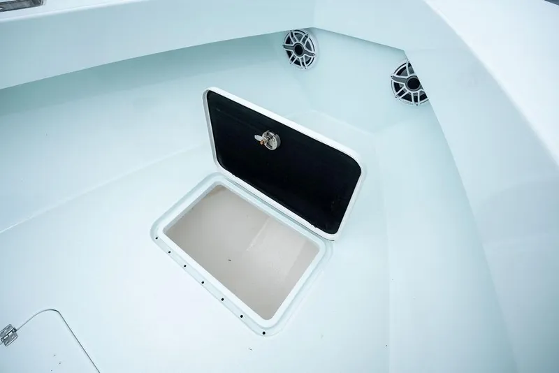 Slide: The Image of 2019 Conch 33 boat interior with open storage compartment and speakers. - 16