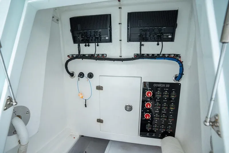 Slide: The Image of Electrical panel of a 2019 Conch 33 boat, featuring wiring and control switches. - 29