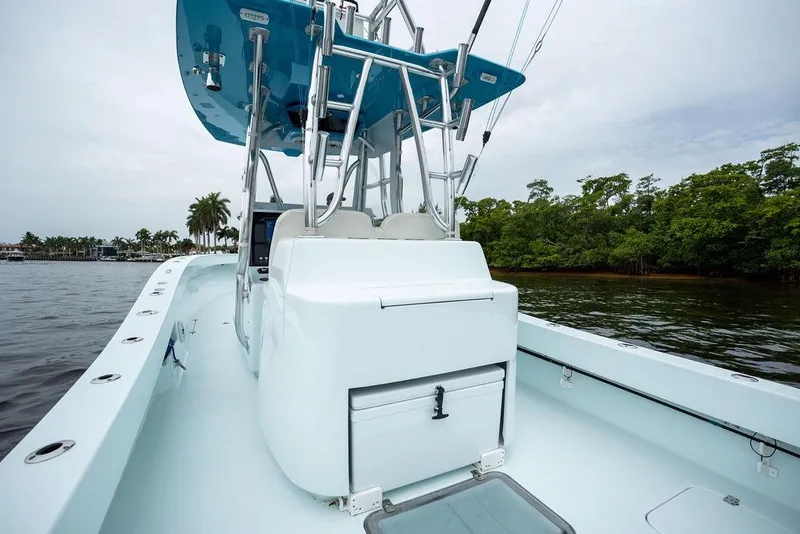 Slide: The Image of 2019 Conch 33 boat with sleek design, docked near lush greenery and calm waters. - 34