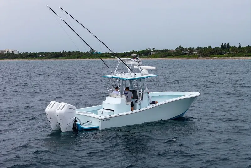 Slide: The Image of 2019 Conch 33 boat on open water with dual Mercury engines. - 12