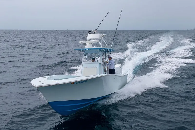 Slide: The Image of 2019 Conch 33 boat cruising on open ocean with fishing rods. - 6