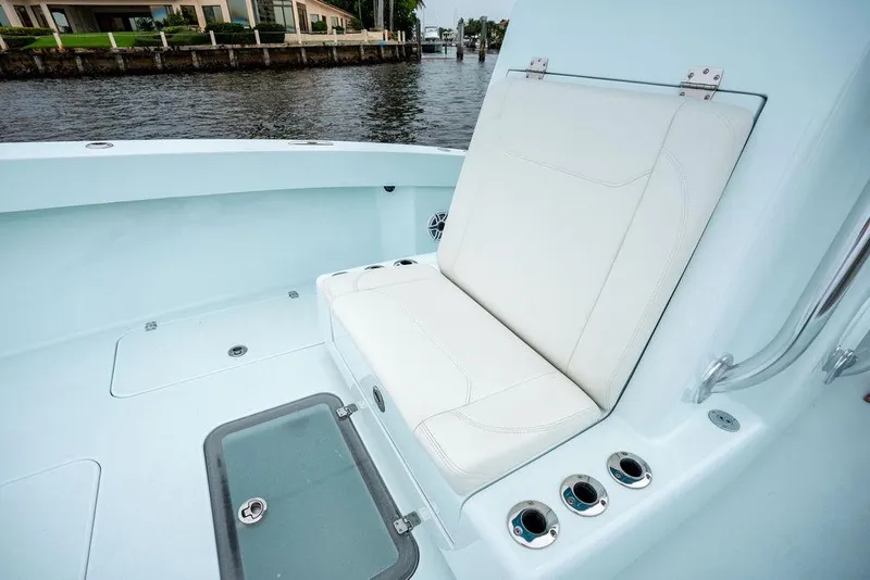 Slide: The Image of 2019 Conch 33 boat interior with white seating and rod holders. - 20