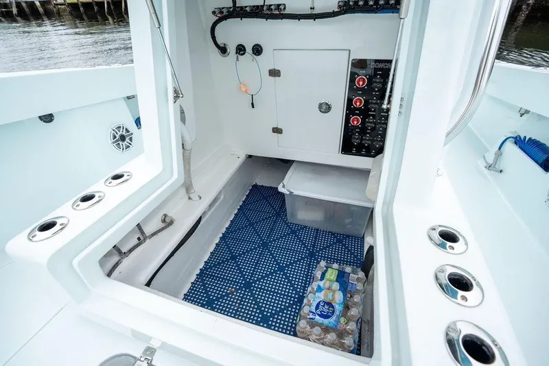 Slide: The Image of Interior view of a 2019 Conch 33 boat, featuring storage and control panel. - 21