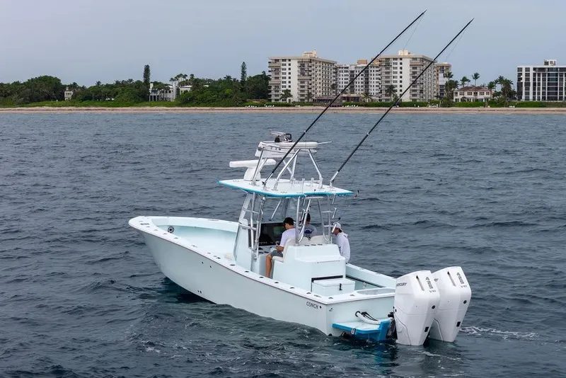 Slide: The Image of 2019 Conch 33 boat on ocean near coastline with buildings in background. - 10