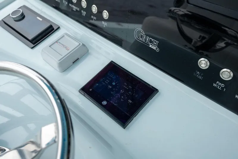 Slide: The Image of Control panel of a 2019 Conch 33 boat with digital display and controls. - 27