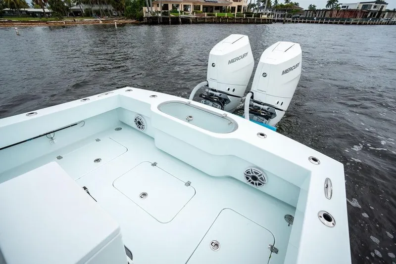 Slide: The Image of 2019 Conch 33 boat with dual Mercury outboard engines on a calm waterway. - 38
