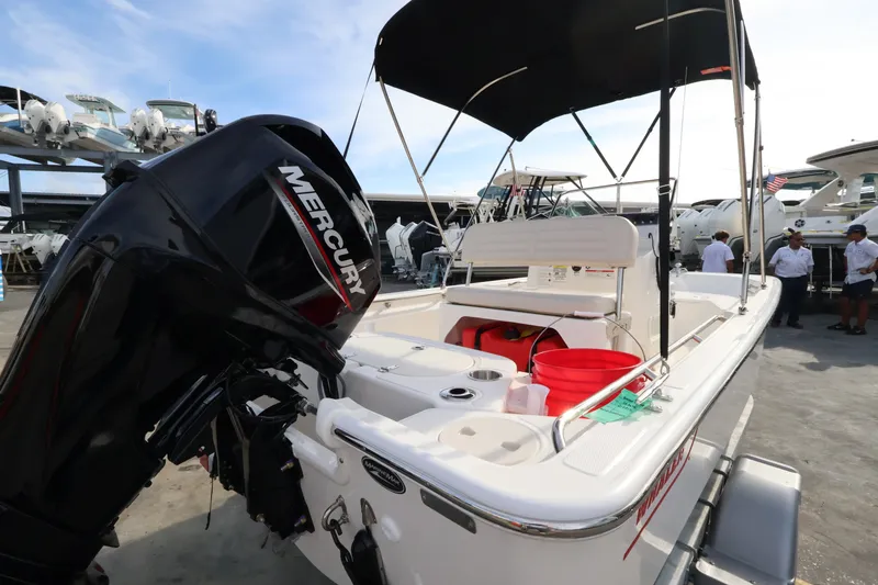 Slide: The Image of A 2027 Boston Whaler 150 Montauk with a Mercury outboard motor, on a boat trailer. - 6