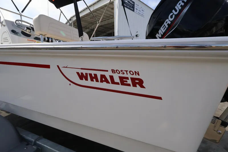 Slide: The Image of Boston Whaler 150 Montauk 2027 with Mercury engine, side view at the dock. - 4