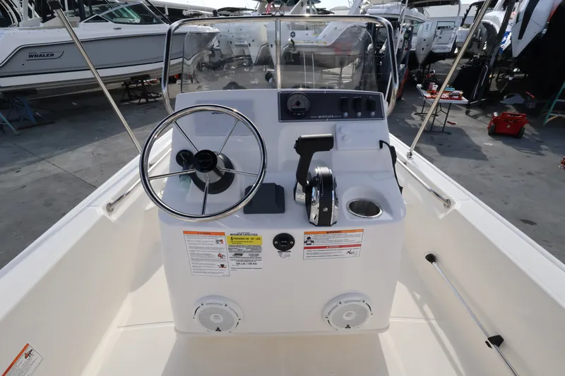Slide: The Image of The image shows the cockpit of a 2027 Boston Whaler 150 Montauk with steering wheel and controls. - 9