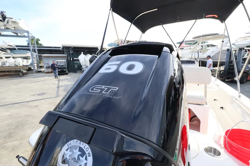 Slide: The Image of A Boston Whaler 150 Montauk with a black outboard motor at the dock. - 5