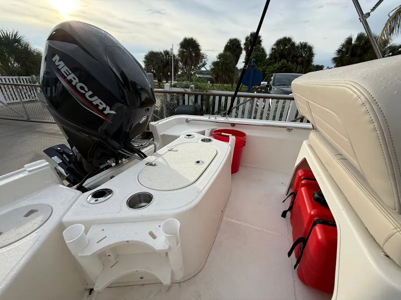 Slide: The Image of The image shows the stern of a Boston Whaler 150 Montauk with a Mercury outboard motor. - 13