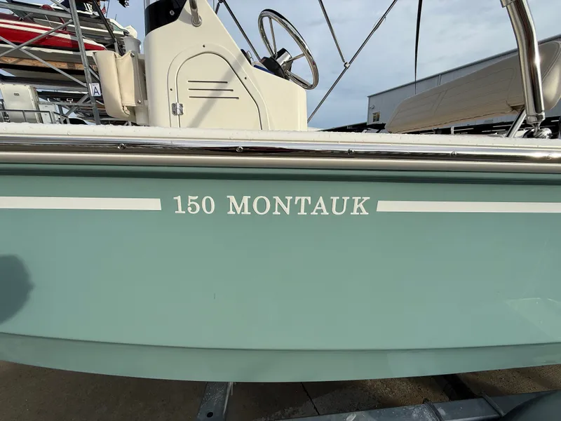 Slide: The Image of Boston Whaler 150 Montauk 2027: Side view with helm and railing. - 15