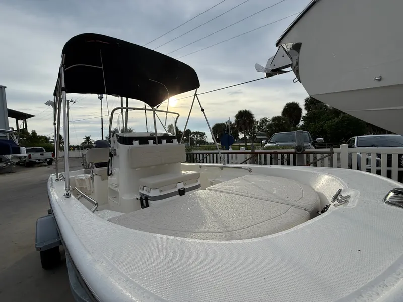 Slide: The Image of Boston Whaler 150 Montauk 2027 with sunshade, on a trailer, ready for adventure. - 8