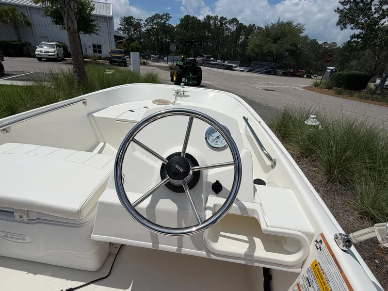 Slide: The Image of The image shows the cockpit of a 2018 Boston Whaler 130 Super Sport with a simple helm. - 6