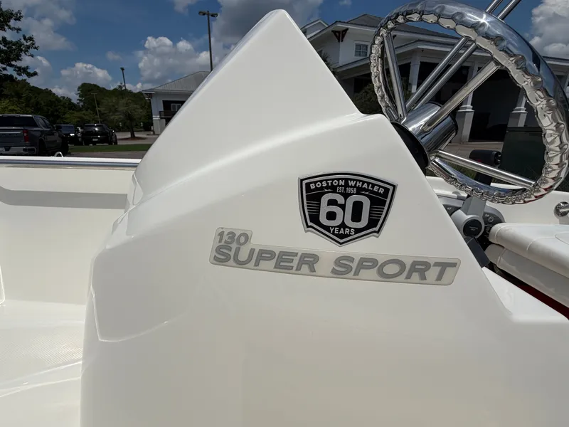 Slide: The Image of Close-up of a 2018 Boston Whaler 130 Super Sport helm with anniversary badge. - 11