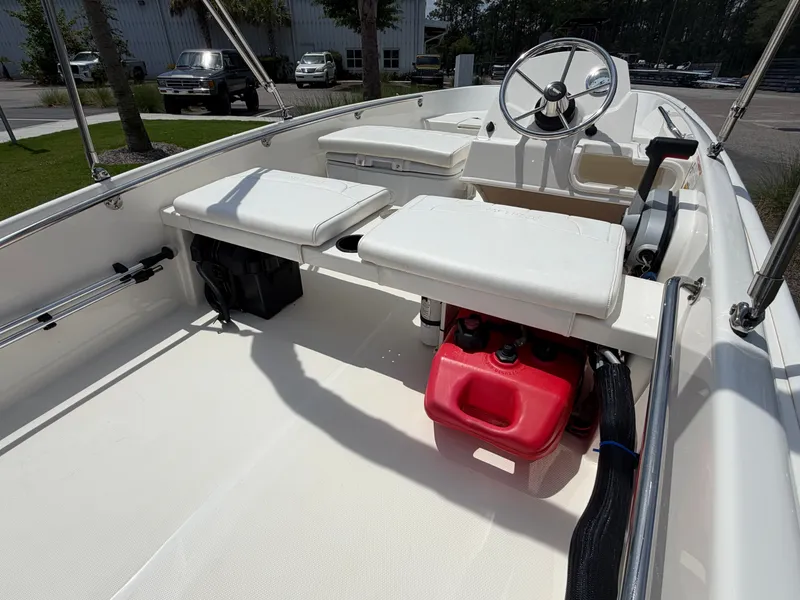 Slide: The Image of The image shows the cockpit of a 2018 Boston Whaler 130 Super Sport with white seats and a red fuel tank. - 5