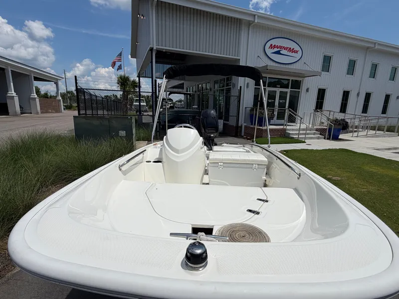 Slide: The Image of A 2018 Boston Whaler 130 Super Sport is parked in front of a modern building. The sky is clear. - 10