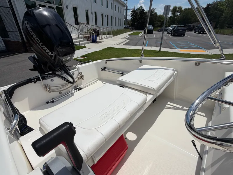 Slide: The Image of The image shows the cockpit of a 2018 Boston Whaler 130 Super Sport with white seating. - 7