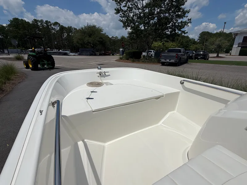 Slide: The Image of The image shows the bow of a 2018 Boston Whaler 130 Super Sport. It is clean and spacious. - 9