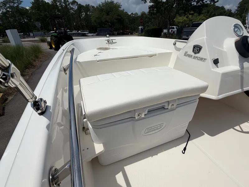 Slide: The Image of The image shows the deck of a 2018 Boston Whaler 130 Super Sport with a white cooler. - 8
