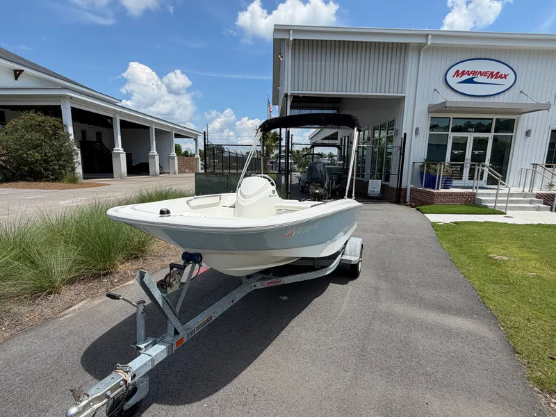 Slide: The Image of A 2018 Boston Whaler 130 Super Sport on a trailer in front of a building. - 1