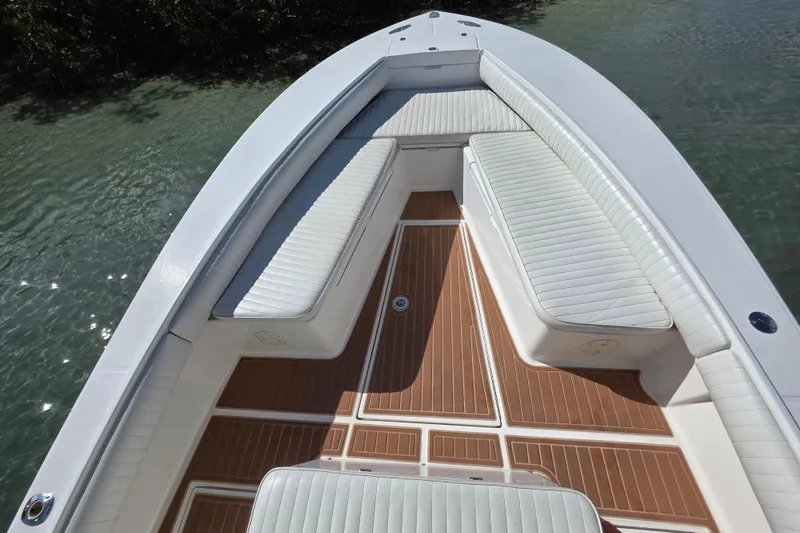 Slide: The Image of 2002 Regulator 26 Center Console boat with cushioned seating and teak-style flooring. - 9