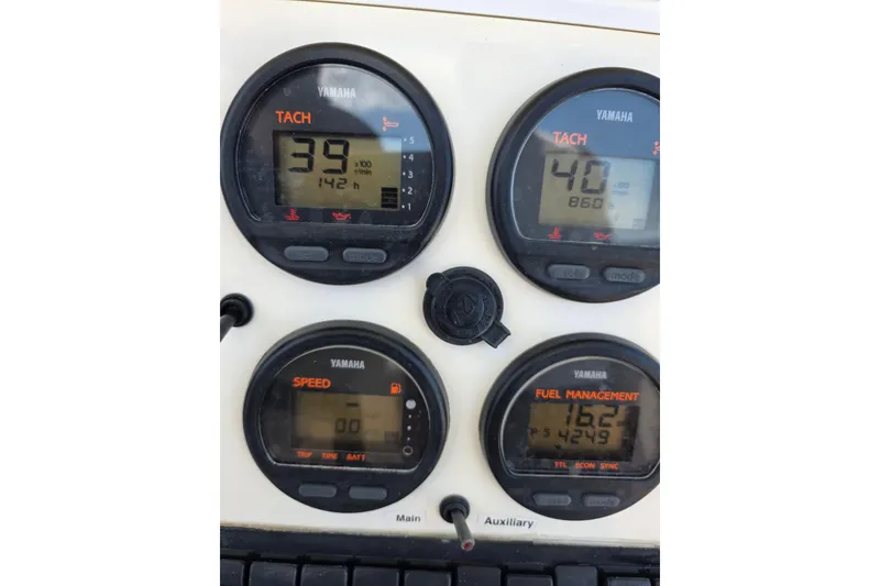 Slide: The Image of Yamaha gauges on a 2002 Regulator 26 Center Console boat dashboard display. - 17