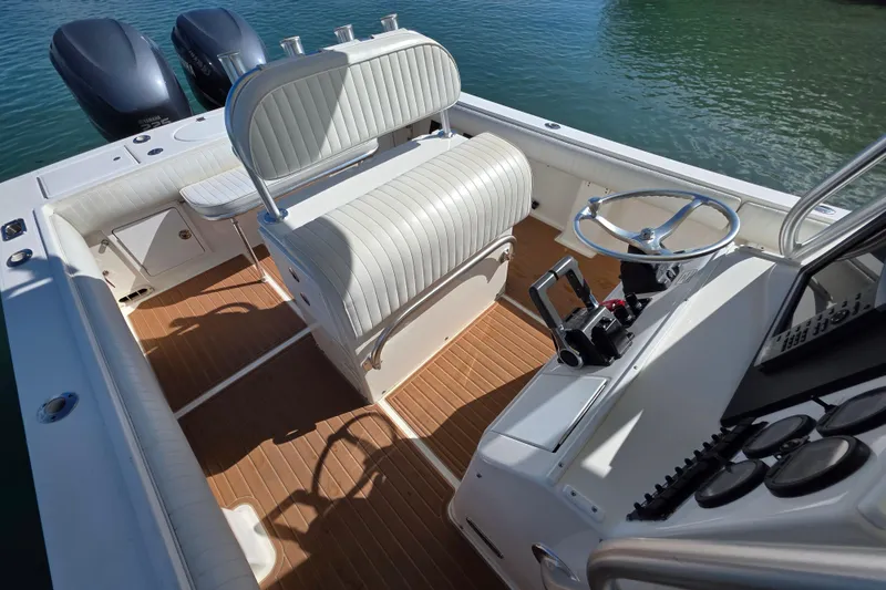 Slide: The Image of 2002 Regulator 26 Center Console boat interior with dual engines and steering wheel. - 12