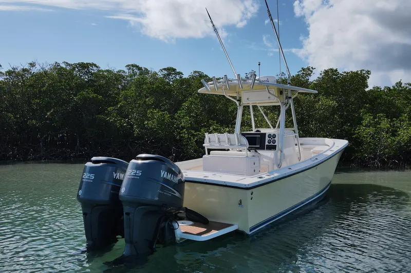 Slide: The Image of 2002 Regulator 26 Center Console boat with twin Yamaha 225 engines in calm waters. - 6